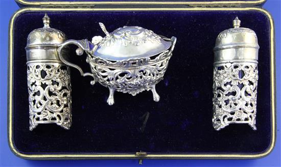 A cased late Victorian silver three piece condiment set by William Hutton & Sons Ltd,